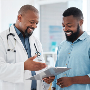 Male health care professional sharing information with male patient